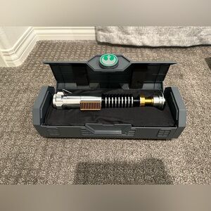 Luke Skywalker legacy lightsaber hilt with stand.